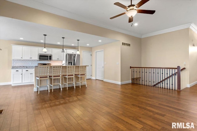 1809 Spartan Dr, Chatham, IL 62629 - kitchen with stainless steel appliances, ceiling fan, dark wood-style flooring, white cabinetry, and decorative backsplash