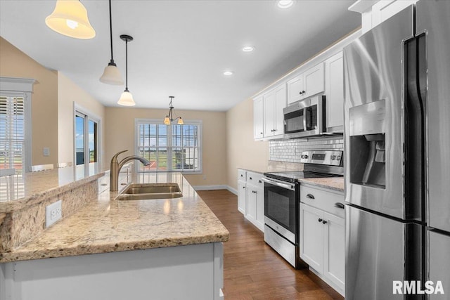 1809 Spartan Dr, Chatham, IL 62629 - kitchen featuring appliances with stainless steel finishes, a sink, dark wood-style flooring, white cabinets, and recessed lighting