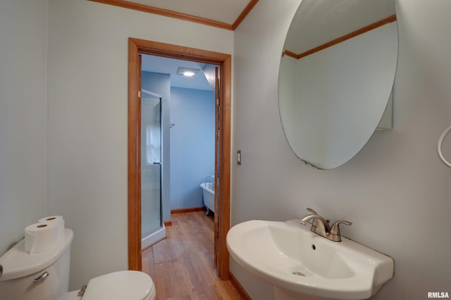 2911 Hampshire St, Quincy, IL 62301 - bathroom featuring toilet, a sink, wood finished floors, crown molding, and a stall shower
