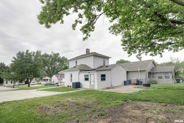 2911 Hampshire St, Quincy, IL 62301 - back of property featuring central AC, a patio area, a yard, and a sunroom
