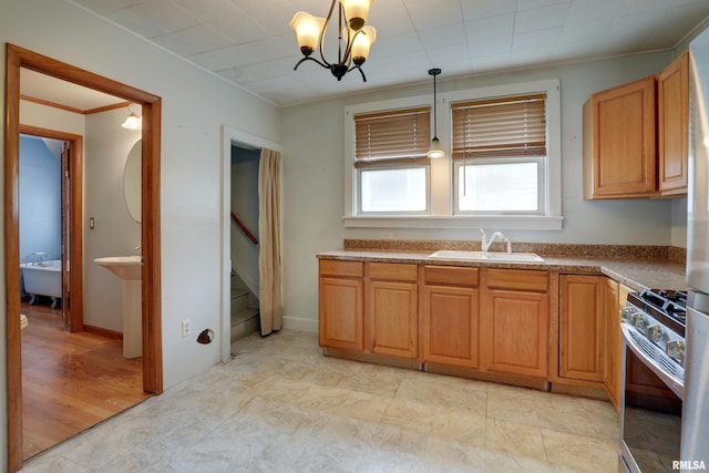2911 Hampshire St, Quincy, IL 62301 - kitchen featuring gas stove, a sink, a chandelier, decorative light fixtures, and crown molding