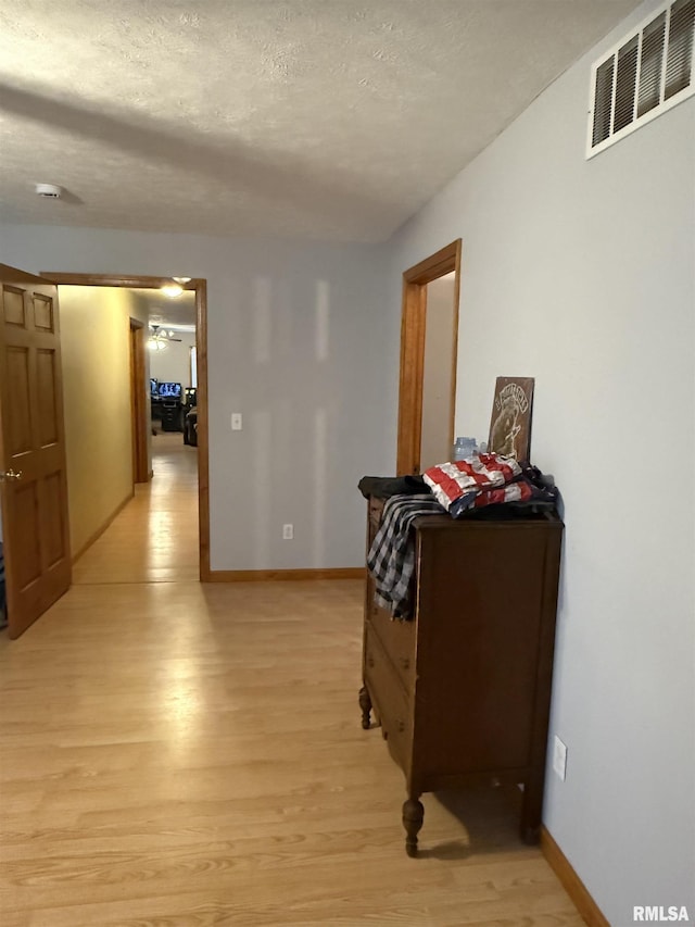 515 Morgan St, Chapin, IL 62628 - hall featuring light wood-style floors, a textured ceiling, and baseboards