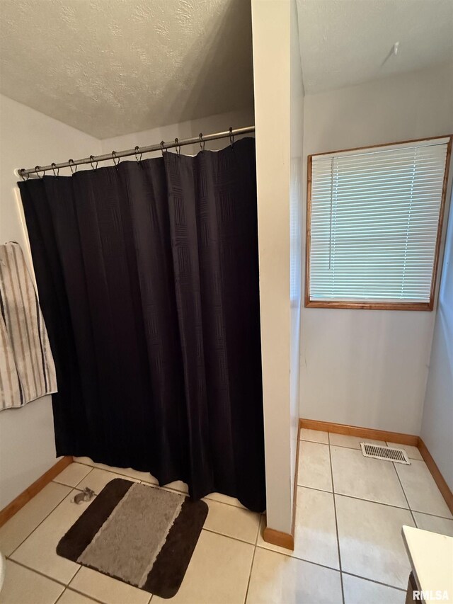 515 Morgan St, Chapin, IL 62628 - bathroom featuring a textured ceiling, tile patterned floors, baseboards, and a shower with curtain