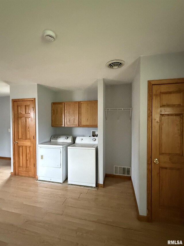 515 Morgan St, Chapin, IL 62628 - laundry room featuring separate washer and dryer, cabinet space, light wood finished floors, and baseboards