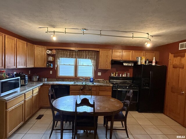 515 Morgan St, Chapin, IL 62628 - kitchen featuring black appliances, light tile patterned floors, ventilation hood, dark countertops, and a sink