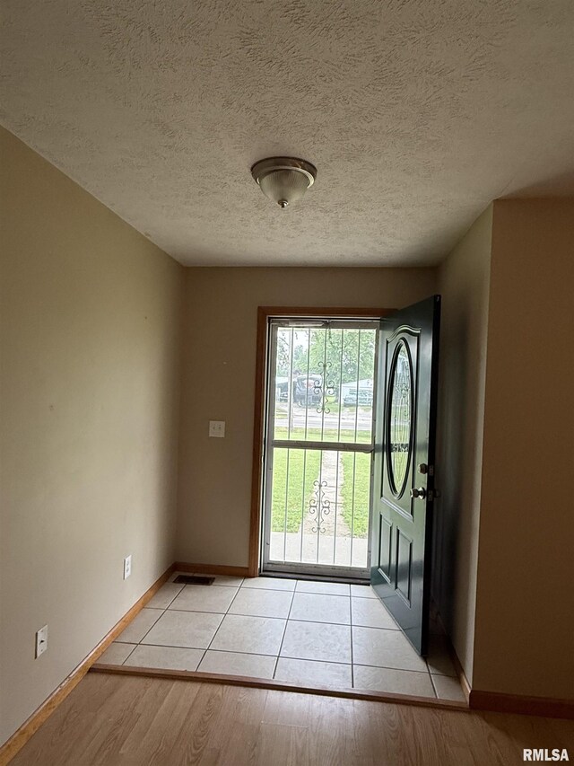 515 Morgan St, Chapin, IL 62628 - entryway featuring baseboards, light wood-style floors, and a textured ceiling