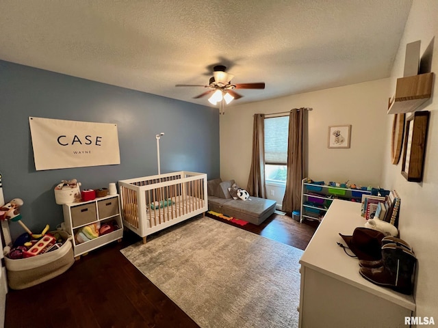 409 W Main St, Williamsville, IL 62693 - bedroom with wood finished floors, a textured ceiling, ceiling fan, and a nursery area