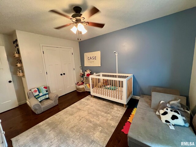 409 W Main St, Williamsville, IL 62693 - bedroom with wood finished floors, a textured ceiling, a closet, a ceiling fan, and a crib
