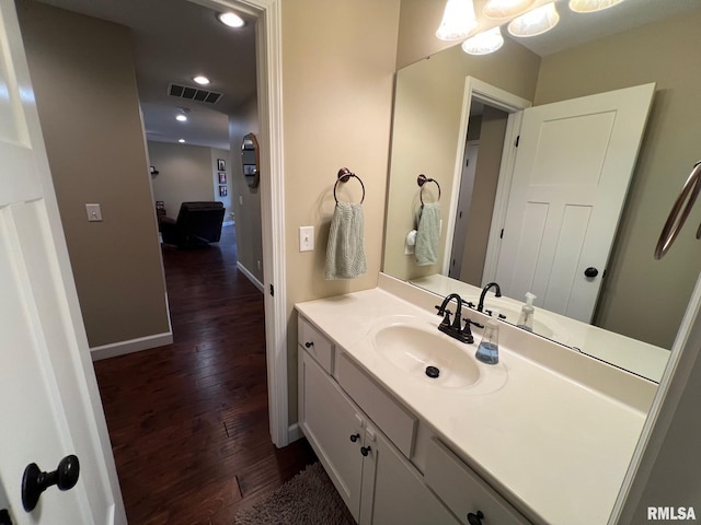 409 W Main St, Williamsville, IL 62693 - bathroom with hardwood / wood-style floors, vanity, and recessed lighting