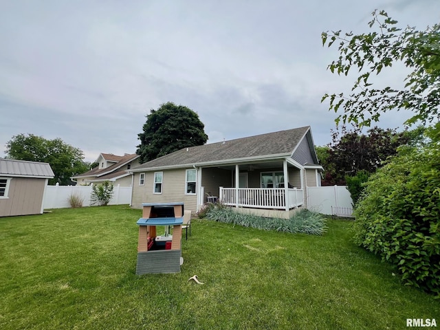 409 W Main St, Williamsville, IL 62693 - back of house featuring a fenced backyard, a storage unit, roof with shingles, and a wooden deck
