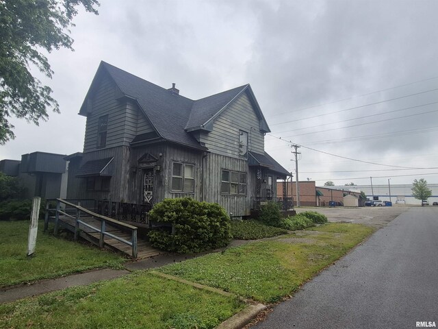 1430 S 8th St, Springfield, IL 62703 - view of home's exterior with a shingled roof and a yard