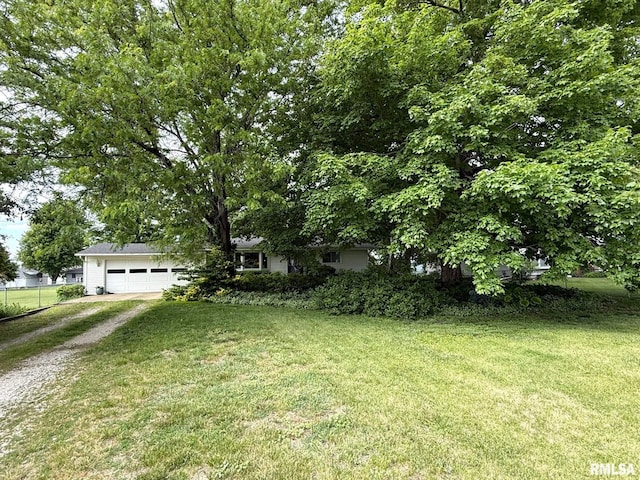 131 E Willard St, Wataga, IL 61488 - view of front of home featuring dirt driveway, an attached garage, and a front lawn