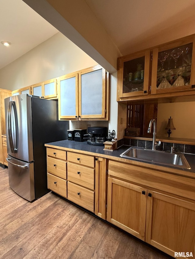 131 E Willard St, Wataga, IL 61488 - kitchen featuring freestanding refrigerator, a sink, light wood-style flooring, glass insert cabinets, and dark countertops