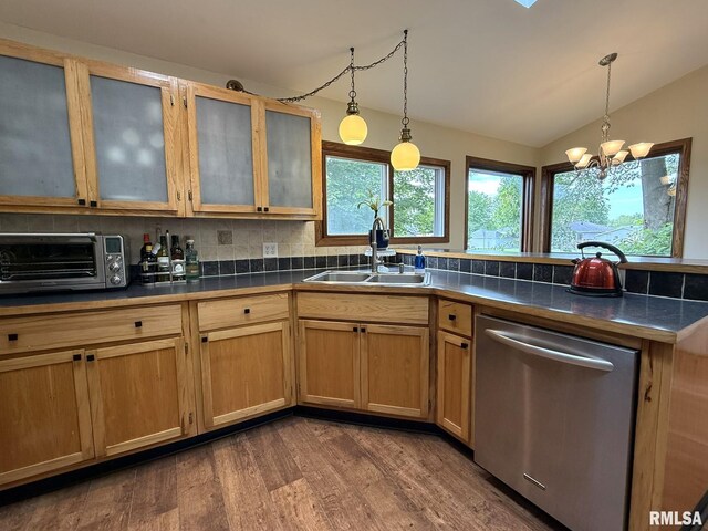131 E Willard St, Wataga, IL 61488 - kitchen with stainless steel dishwasher, a sink, dark wood-style floors, a peninsula, and vaulted ceiling