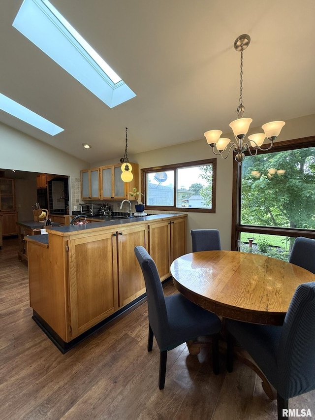131 E Willard St, Wataga, IL 61488 - dining space with dark wood-style floors, a skylight, vaulted ceiling, a chandelier, and recessed lighting