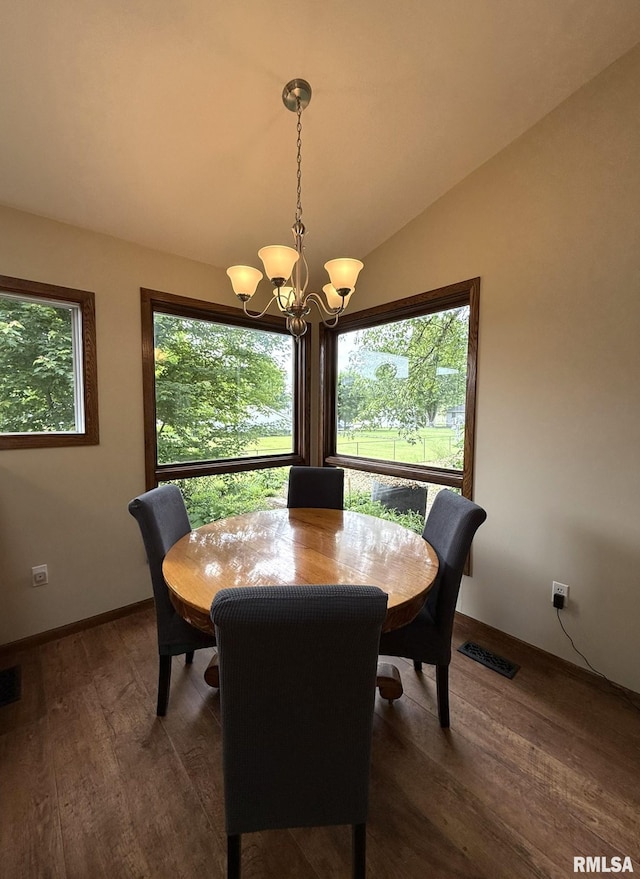 131 E Willard St, Wataga, IL 61488 - dining space with a chandelier, dark wood-style floors, baseboards, and vaulted ceiling