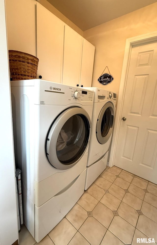 131 E Willard St, Wataga, IL 61488 - washroom featuring washer and clothes dryer, cabinet space, and light tile patterned floors
