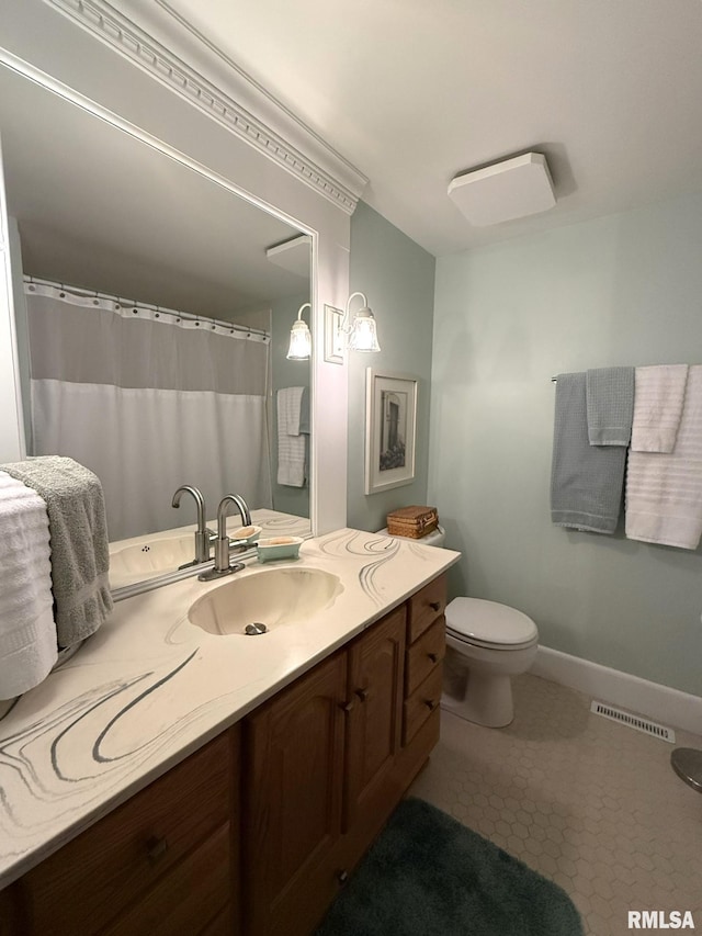 131 E Willard St, Wataga, IL 61488 - bathroom featuring toilet, vanity, baseboards, and tile patterned flooring
