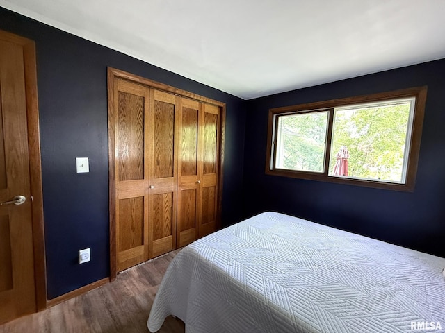 131 E Willard St, Wataga, IL 61488 - bedroom with dark wood-style flooring, a closet, and baseboards