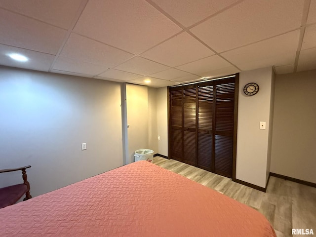 131 E Willard St, Wataga, IL 61488 - bedroom with light wood-style flooring, a drop ceiling, baseboards, a closet, and recessed lighting