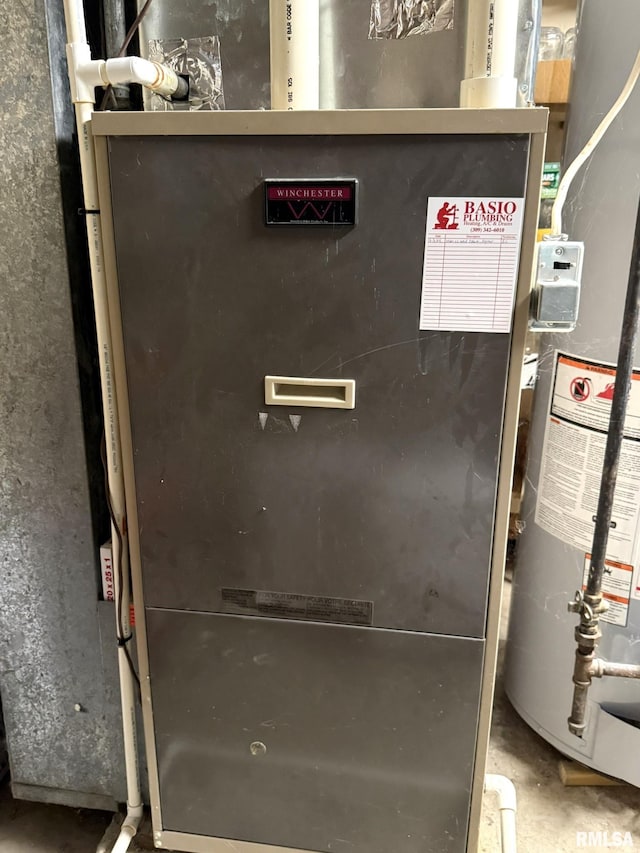 131 E Willard St, Wataga, IL 61488 - utility room with water heater and heating unit