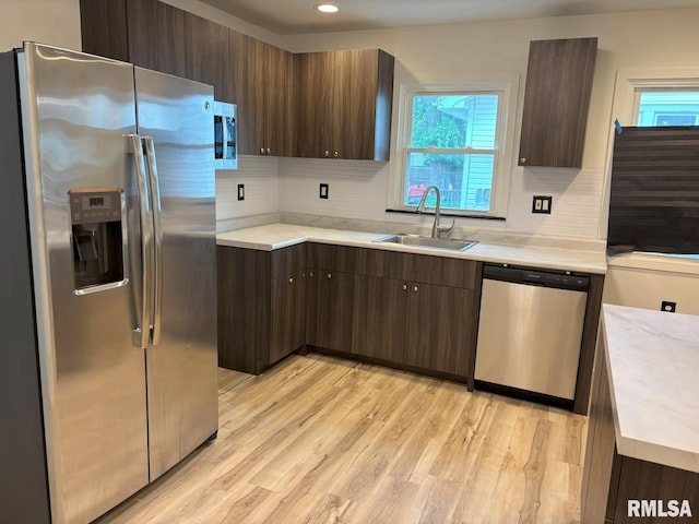 1614 E Converse Ave, Springfield, IL 62702 - kitchen featuring appliances with stainless steel finishes, a sink, light countertops, light wood-style flooring, and recessed lighting