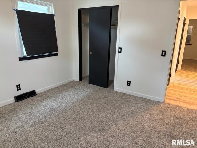 1614 E Converse Ave, Springfield, IL 62702 - unfurnished bedroom featuring carpet, baseboards, and a closet