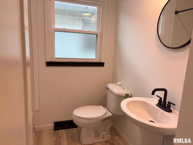 1614 E Converse Ave, Springfield, IL 62702 - half bath with toilet, a sink, wood finished floors, and baseboards