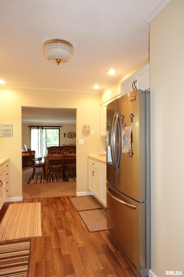 255 S Soangetaha Rd, Galesburg, IL 61401 - kitchen with stainless steel refrigerator with ice dispenser, white cabinetry, wood finished floors, light countertops, and recessed lighting