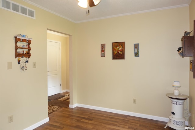 255 S Soangetaha Rd, Galesburg, IL 61401 - spare room featuring dark wood finished floors, ornamental molding, baseboards, and ceiling fan