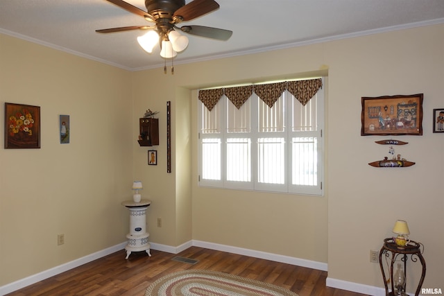 255 S Soangetaha Rd, Galesburg, IL 61401 - empty room featuring dark wood-style flooring, ceiling fan, crown molding, and baseboards