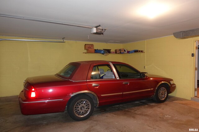 255 S Soangetaha Rd, Galesburg, IL 61401 - garage featuring concrete block wall and a garage door opener