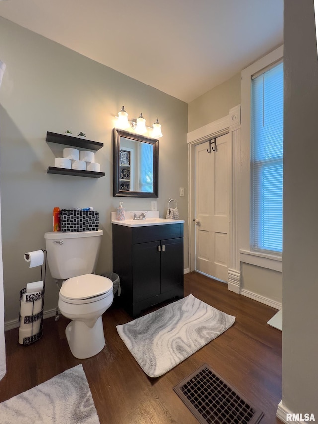 306 N Jefferson St, Abingdon, IL 61410 - bathroom with vanity, wood finished floors, toilet, and baseboards