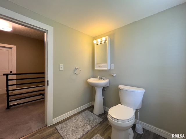306 N Jefferson St, Abingdon, IL 61410 - bathroom featuring toilet, wood finished floors, and baseboards