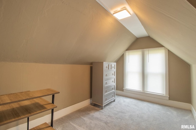 306 N Jefferson St, Abingdon, IL 61410 - additional living space with light colored carpet, lofted ceiling, and baseboards