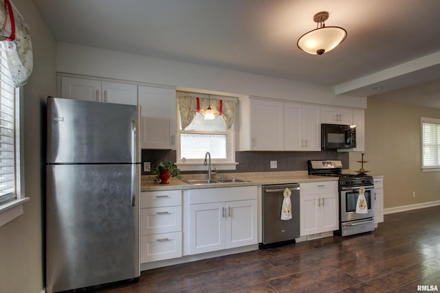 2016 Sycamore St, Quincy, IL 62301 - kitchen featuring stainless steel appliances, a sink, backsplash, and white cabinetry
