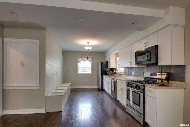 2016 Sycamore St, Quincy, IL 62301 - kitchen featuring appliances with stainless steel finishes, white cabinetry, baseboards, decorative backsplash, and recessed lighting