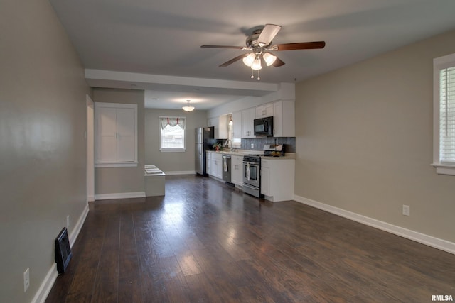 2016 Sycamore St, Quincy, IL 62301 - living room with a ceiling fan, baseboards, and dark wood-type flooring
