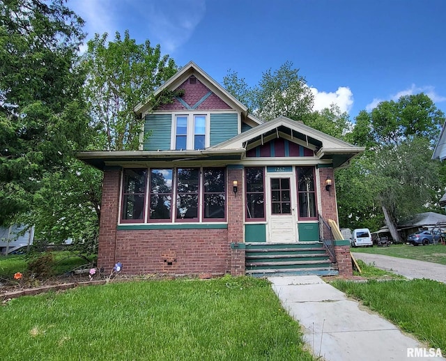 1262 N Broad St, Galesburg, IL 61401 - view of front of home with a front lawn, brick siding, and entry steps