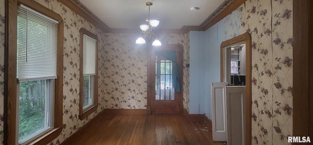 1262 N Broad St, Galesburg, IL 61401 - unfurnished dining area with wood-type flooring, wallpapered walls, a chandelier, baseboards, and ornamental molding