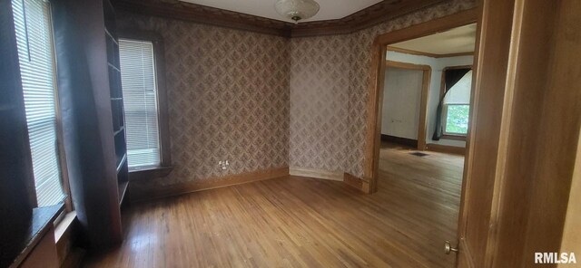 1262 N Broad St, Galesburg, IL 61401 - unfurnished room with baseboards, wood finished floors, ornamental molding, and wallpapered walls