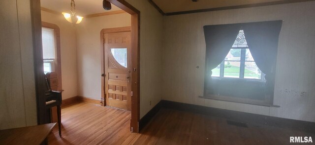 1262 N Broad St, Galesburg, IL 61401 - foyer entrance with crown molding, wood finished floors, and baseboards