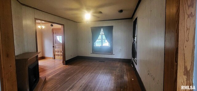 1262 N Broad St, Galesburg, IL 61401 - spare room featuring ornamental molding, dark wood-style floors, and baseboards
