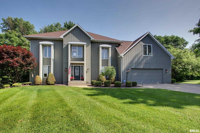 507 W Fairway Dr, Quincy, IL 62305 - view of front of home with an attached garage, concrete driveway, a front lawn, and a shingled roof