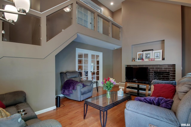 507 W Fairway Dr, Quincy, IL 62305 - living area featuring wood finished floors, baseboards, a chandelier, a towering ceiling, and french doors