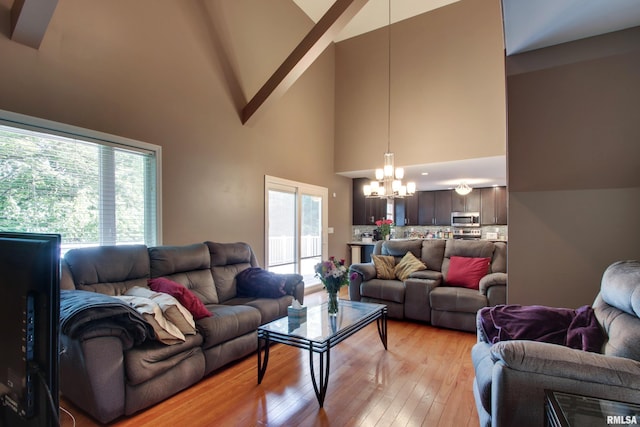 507 W Fairway Dr, Quincy, IL 62305 - living area with high vaulted ceiling, a chandelier, and light wood-type flooring