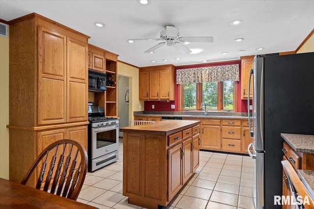 7 Marshall Ct, Springfield, IL 62563 - kitchen featuring appliances with stainless steel finishes, a ceiling fan, light tile patterned floors, a center island, and a sink
