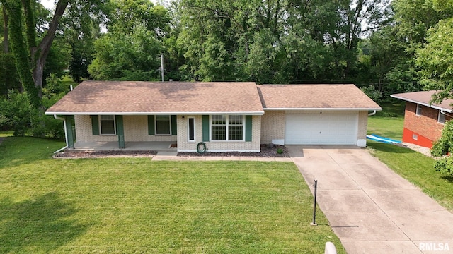 1246 Curtis Creek Rd, Quincy, IL 62301 - ranch-style home with an attached garage, covered porch, driveway, brick siding, and a front lawn