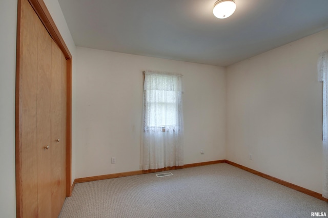 2044 N 1200th Ave, Liberty, IL 62347 - unfurnished bedroom with light colored carpet, a closet, and baseboards