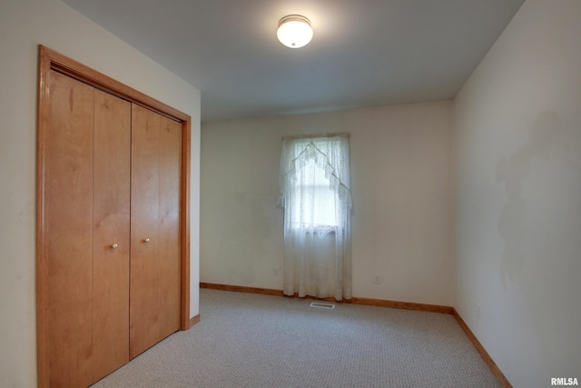 2044 N 1200th Ave, Liberty, IL 62347 - unfurnished bedroom with light carpet, baseboards, and a closet